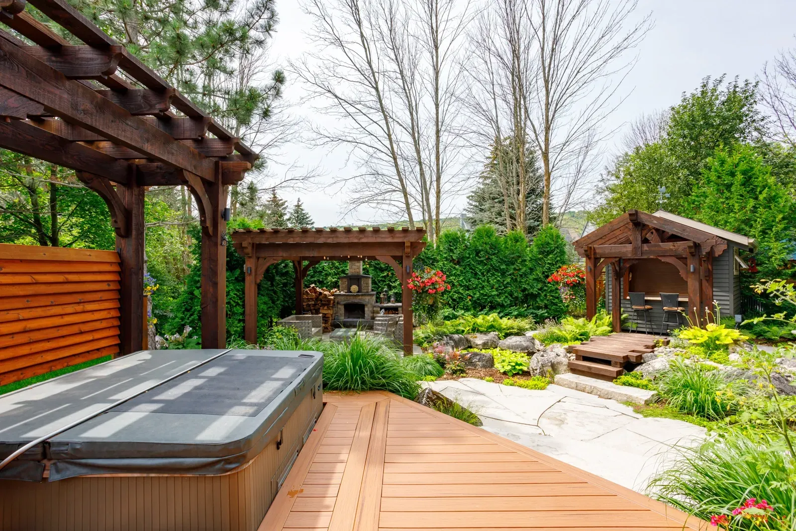 There is a hot tub on the deck in the backyard.