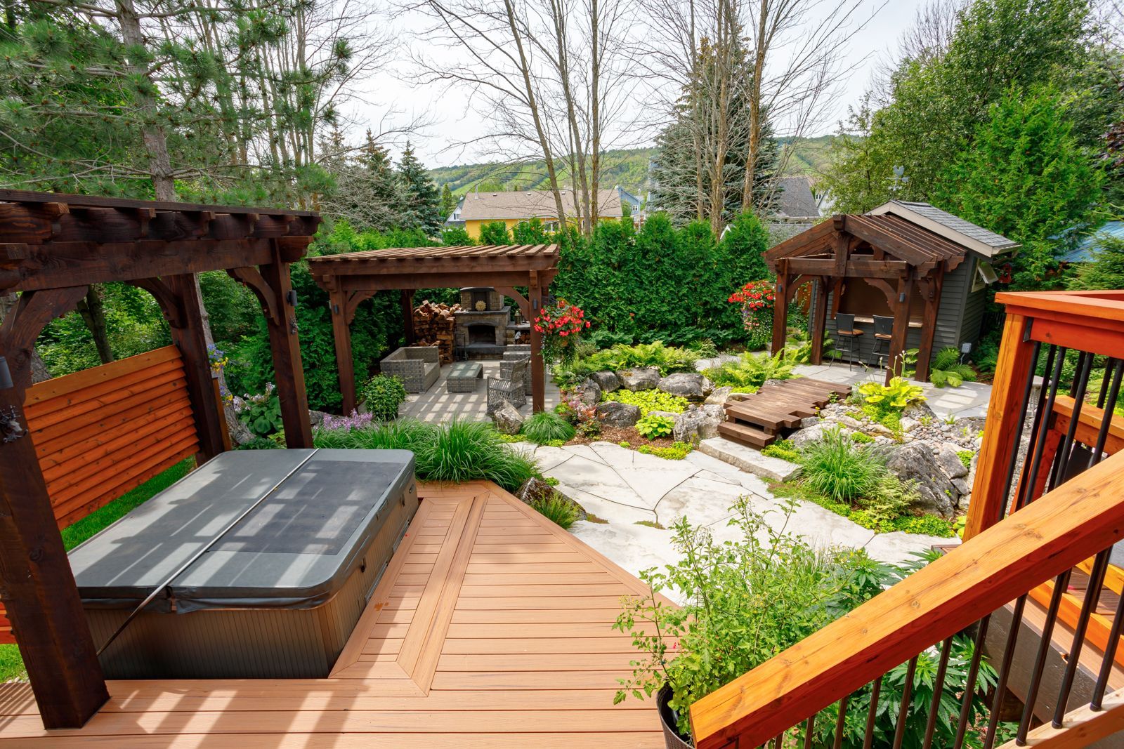 There is a hot tub on the deck of a house.