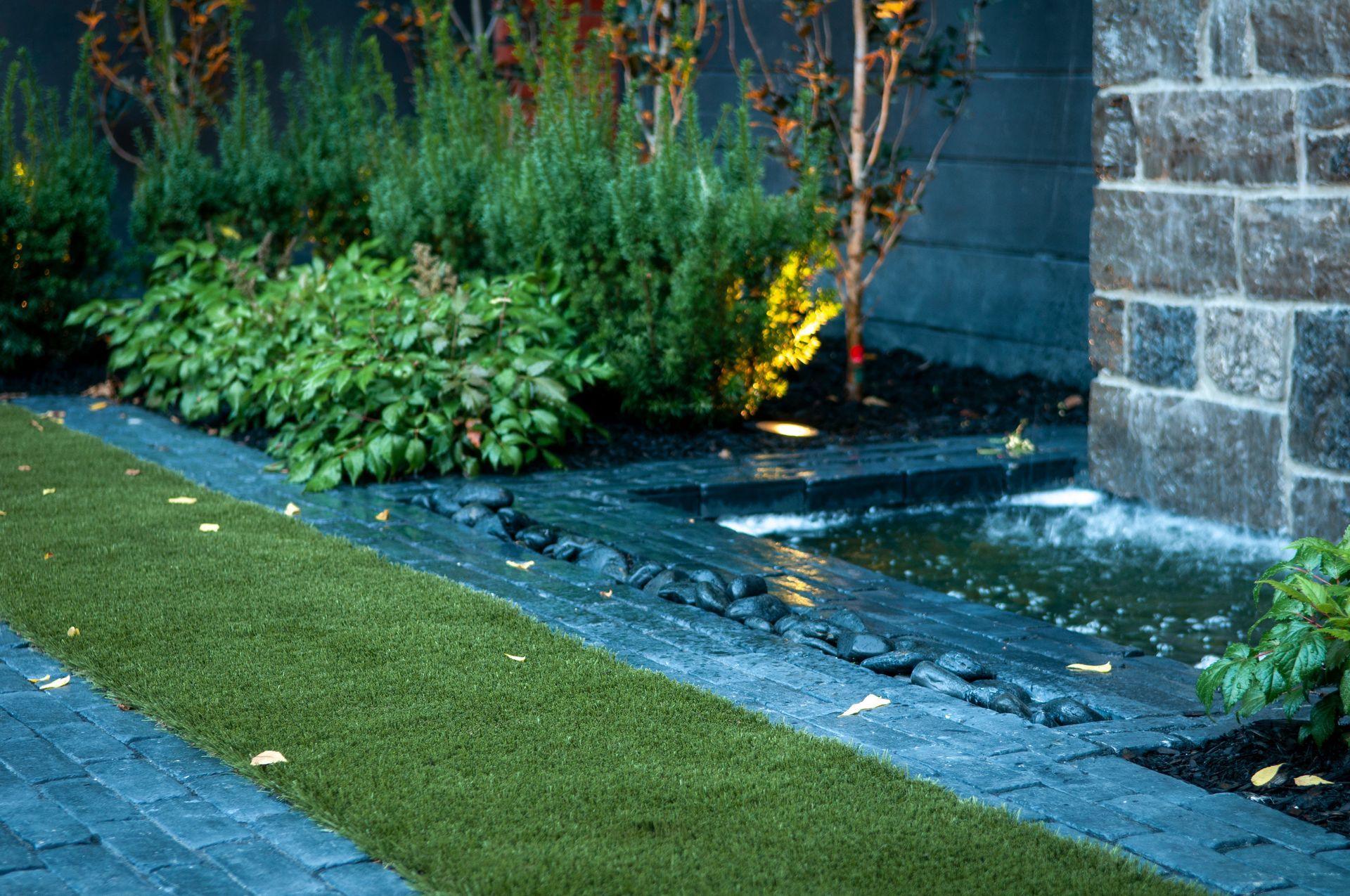 There is a waterfall in the middle of the yard.