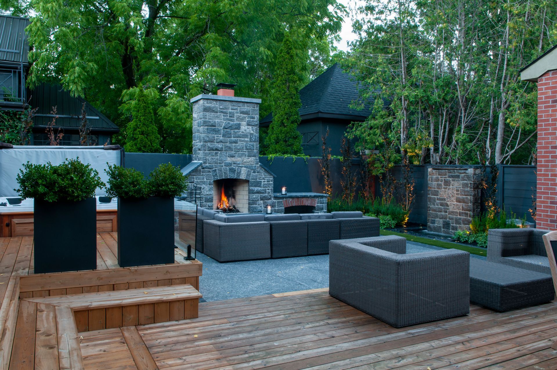 There is a fireplace in the backyard with a lot of furniture.