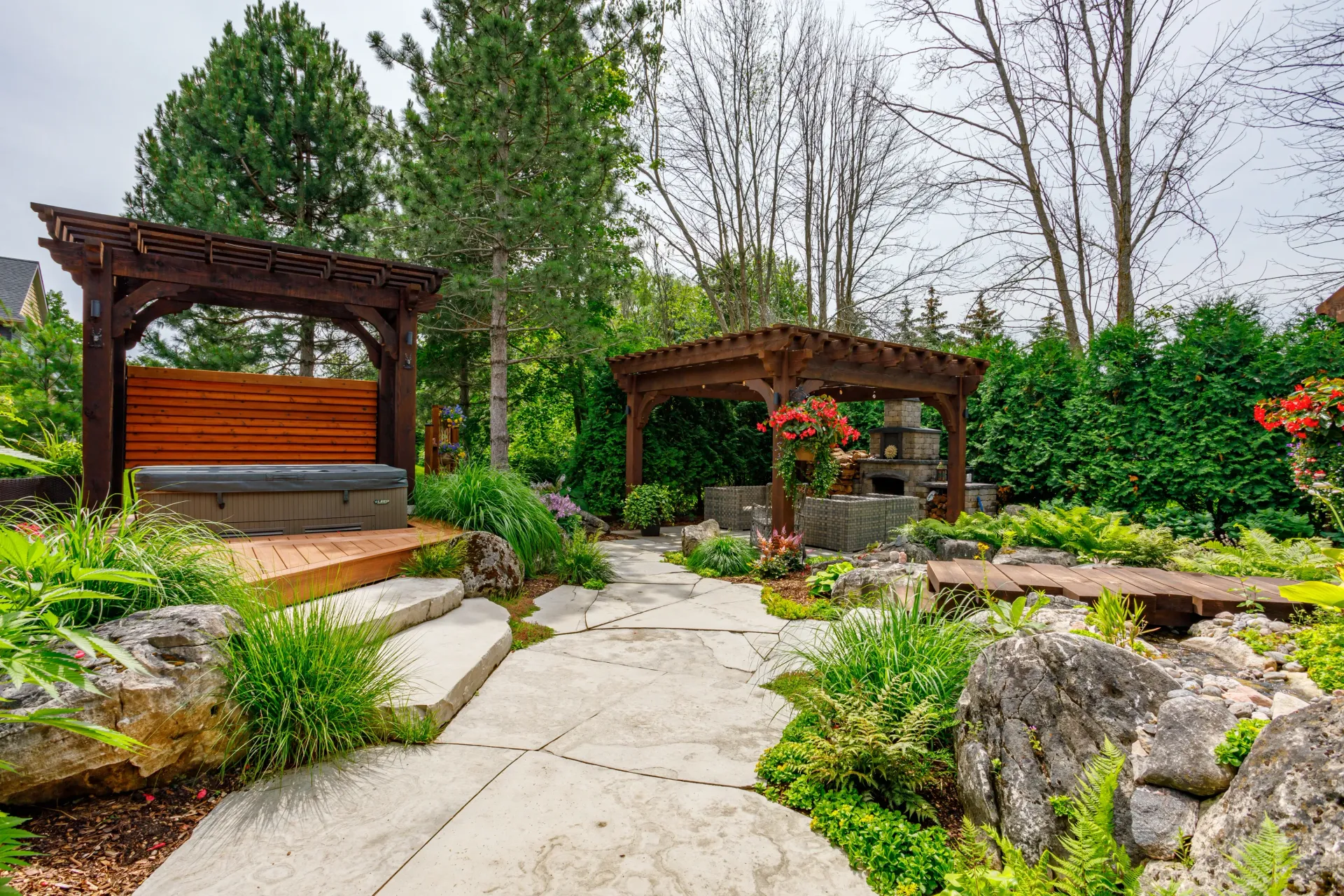 There is a wooden pergola in the middle of the garden.
