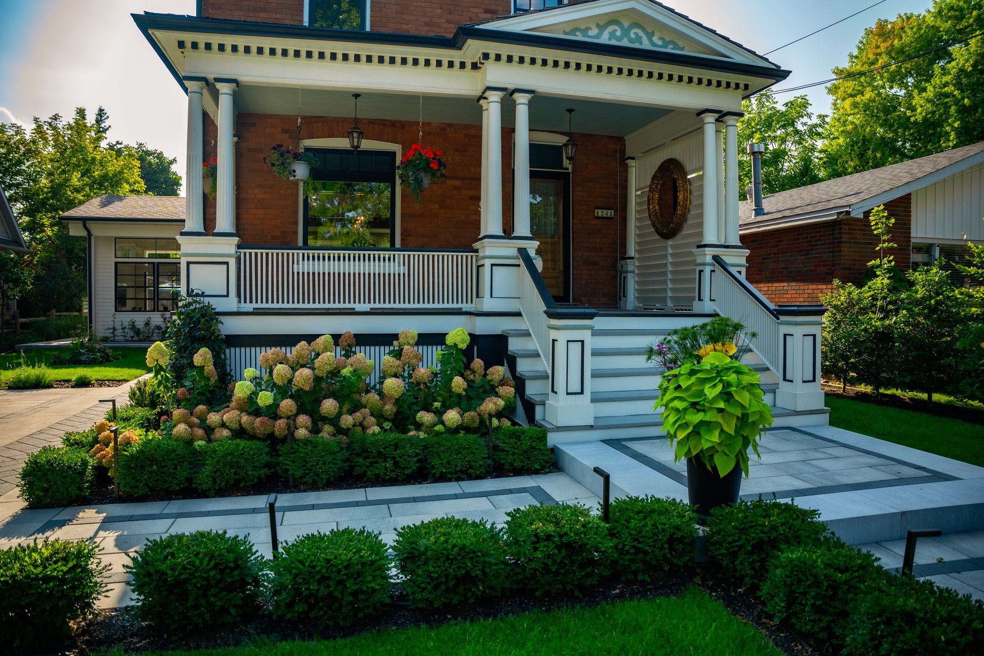 A large brick house with a porch and stairs