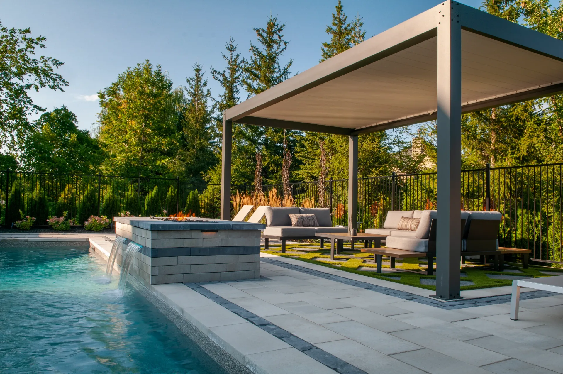 A swimming pool with a pergola and a fire pit in the backyard.