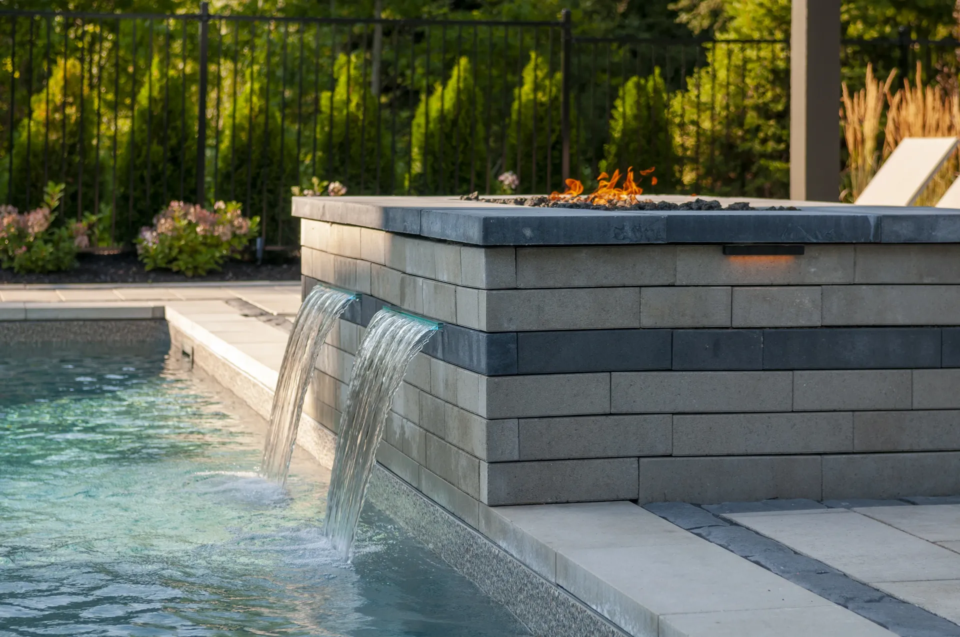 There is a waterfall in the middle of the pool.
