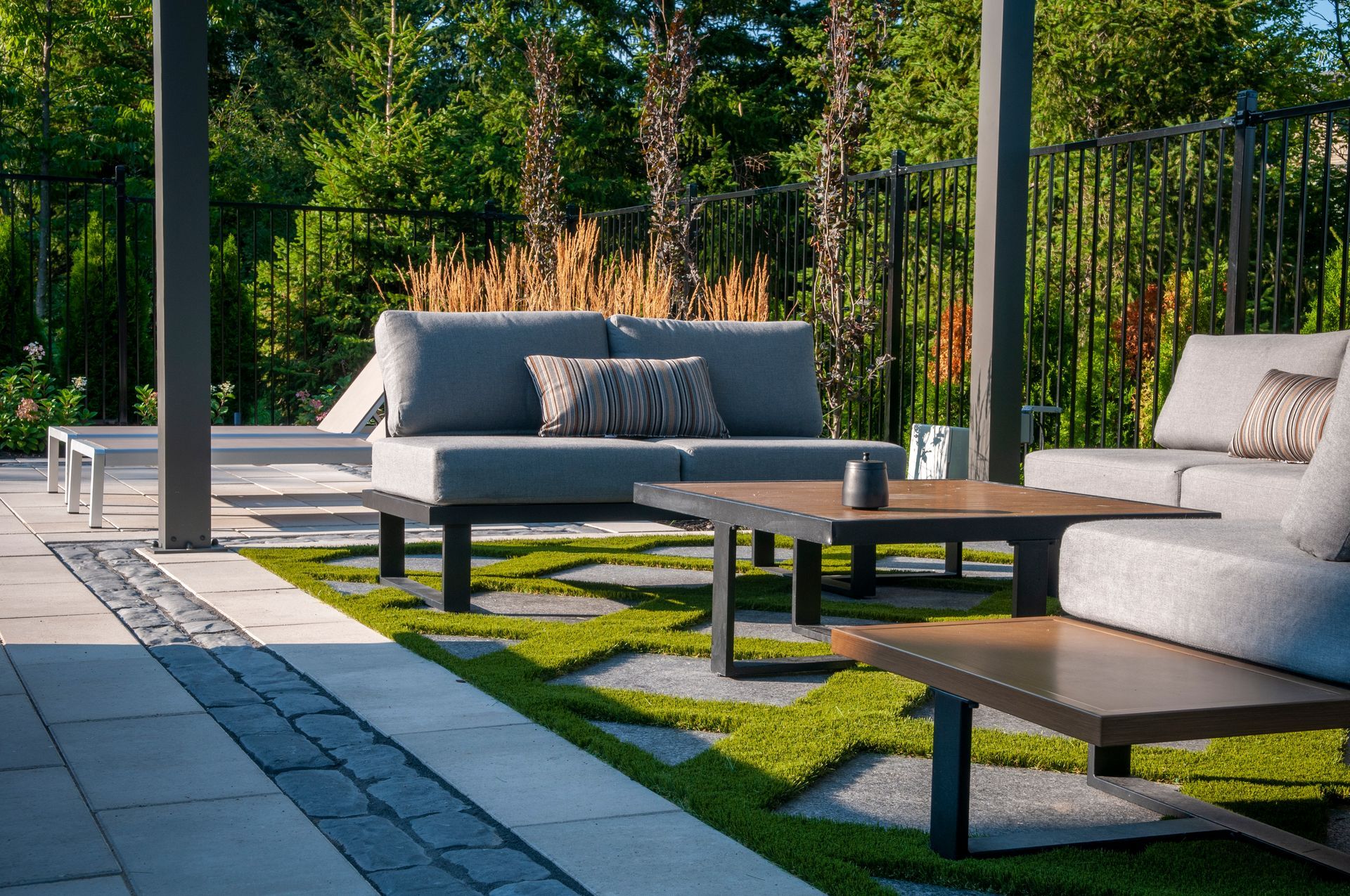 A patio with a couch , chairs , and a table.