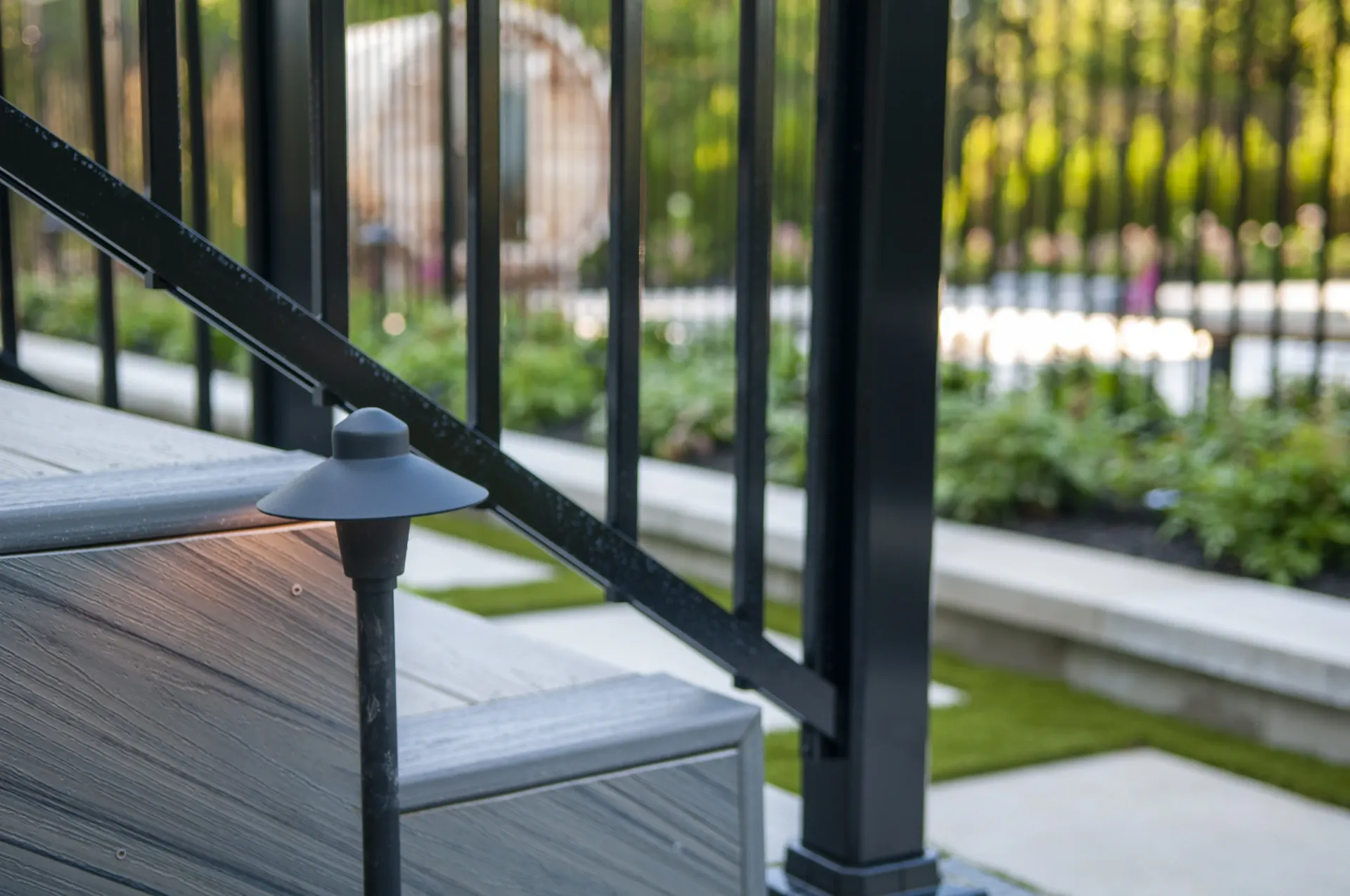 A close up of a deck with stairs and a railing.