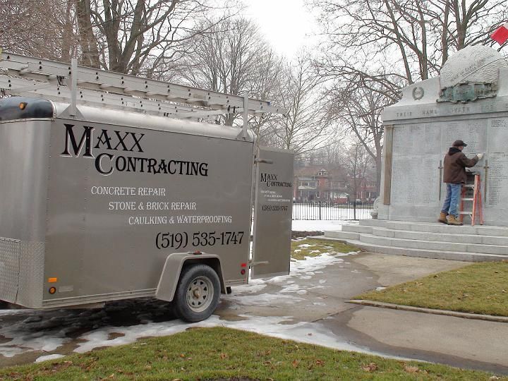 a maxx contracting trailer is parked in front of a monument