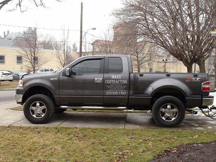 a maxx contracting truck is parked on the side of the road