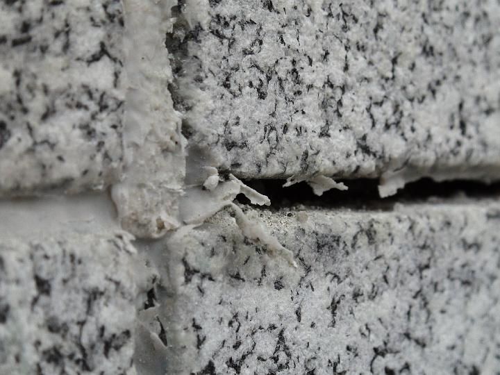 a close up of a brick wall with a hole in it