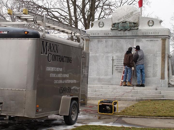 a maxx contracting trailer is parked in front of a monument