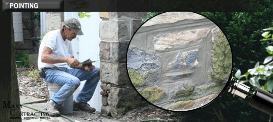 a man is pointing at a stone wall with a magnifying glass .