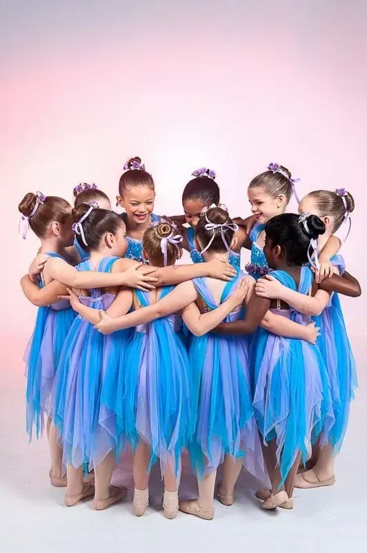 A Group Of Young Girls In Blue Dresses Are Hugging Each Other — International Dance Affair In North Mackay, QLD