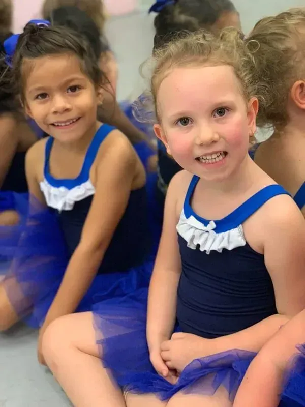 A Group Of Young Girls Are Sitting On The Floor Wearing Blue Tutus — International Dance Affair In North Mackay, QLD
