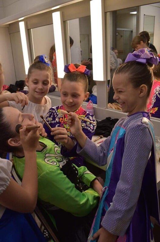 A Group Of Young Girls Are Getting Their Makeup Done In A Dressing Room — International Dance Affair In North Mackay, QLD