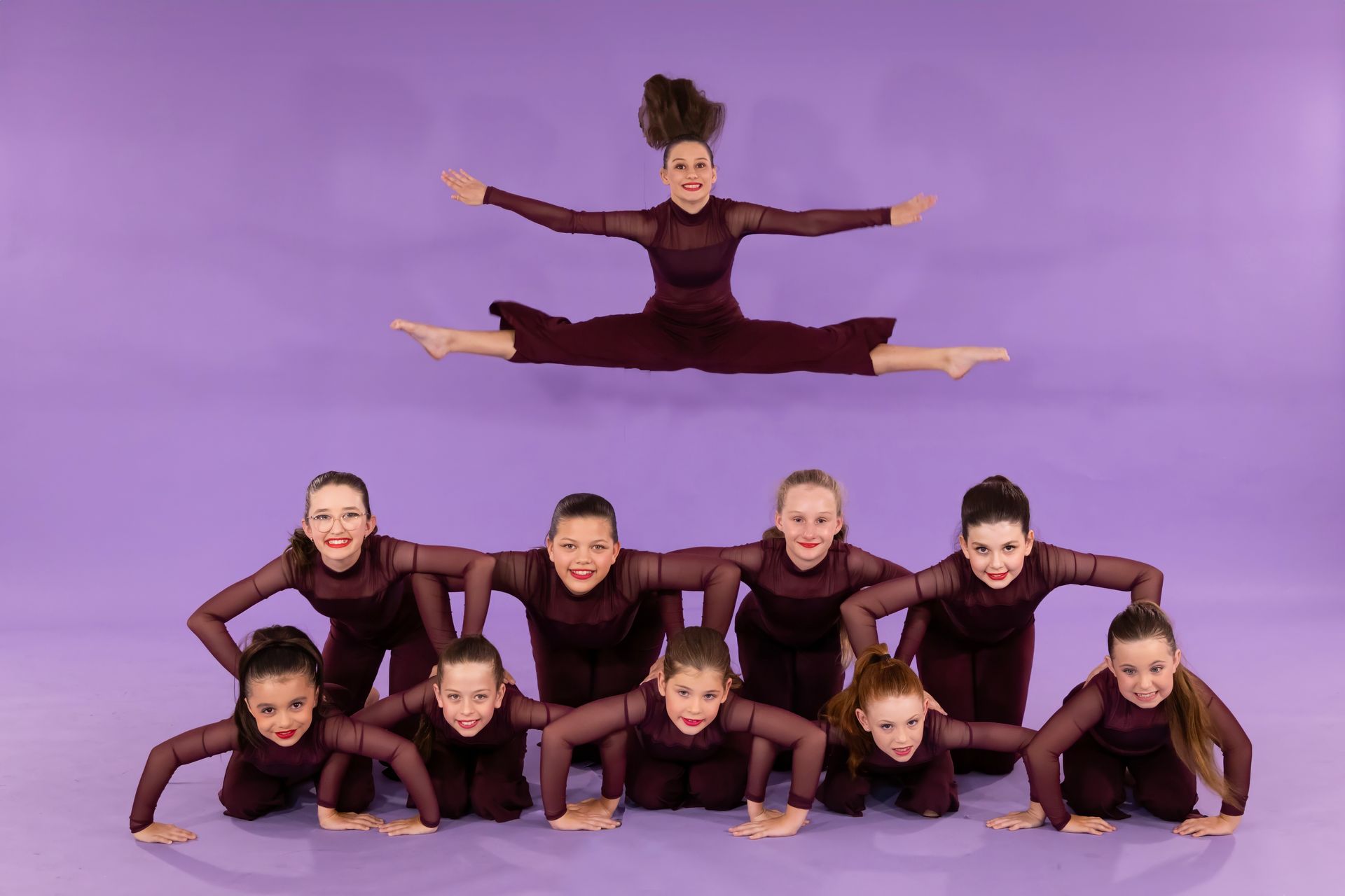A Group Of Young Girls Are Posing For A Picture In Front Of A Purple Background — International Dance Affair In North Mackay, QLD