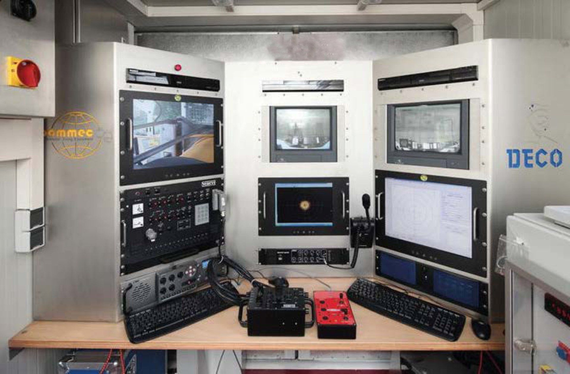 ROV control panel with multiple screens, buttons, and a camera view. 