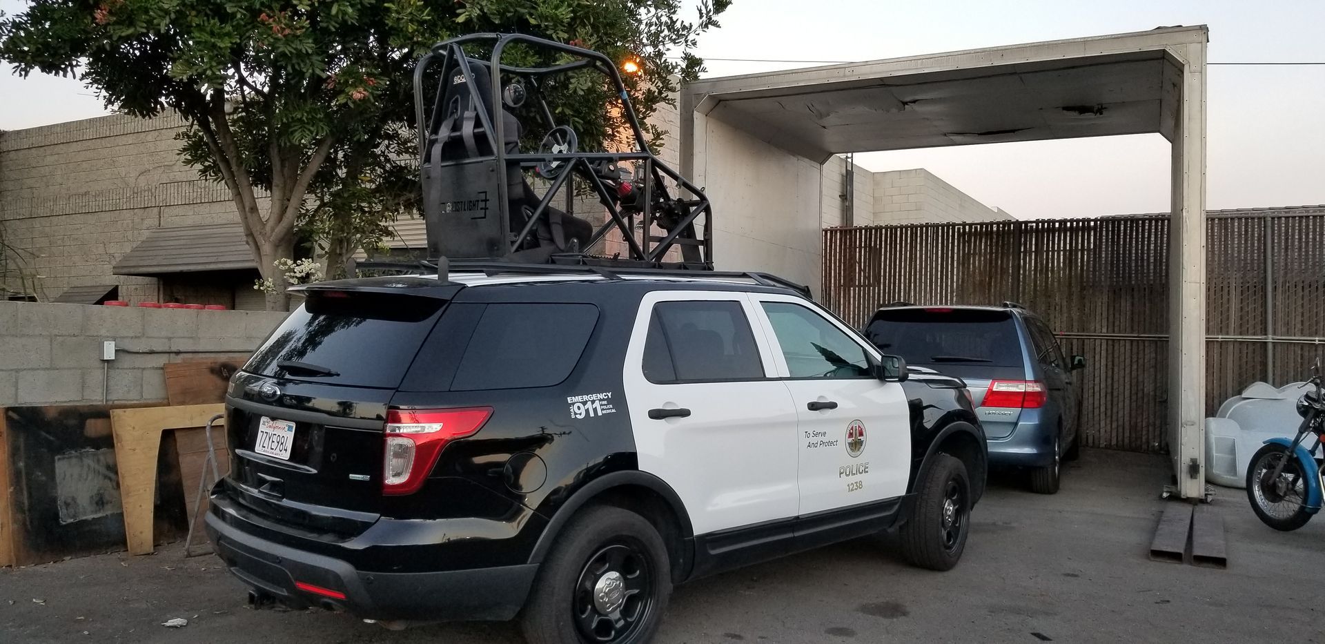 A black and white car is parked and ready to install pod rigs for film shooting.