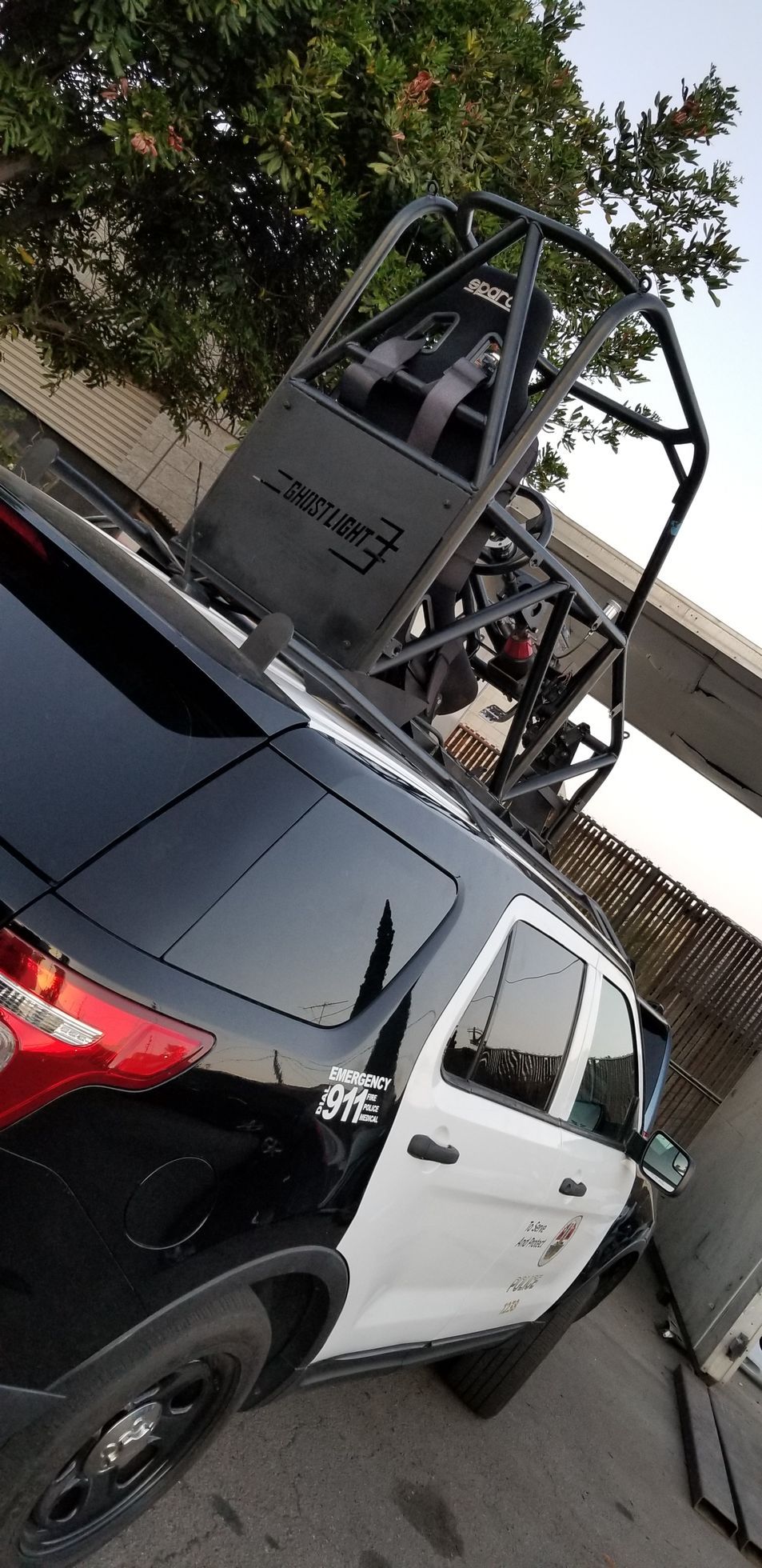 A black and white police car is parked and ready to install pod rigs for film shooting.