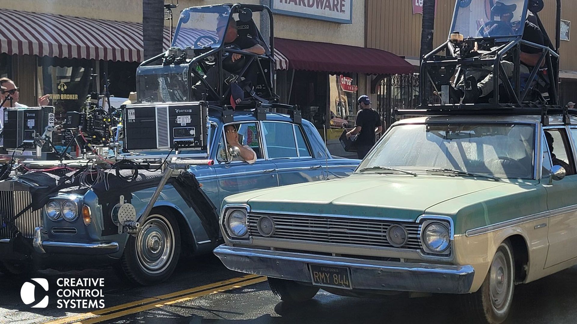 A parked car on the street with pedestrians in the background, highlighting enhanced safety protocols for film production.