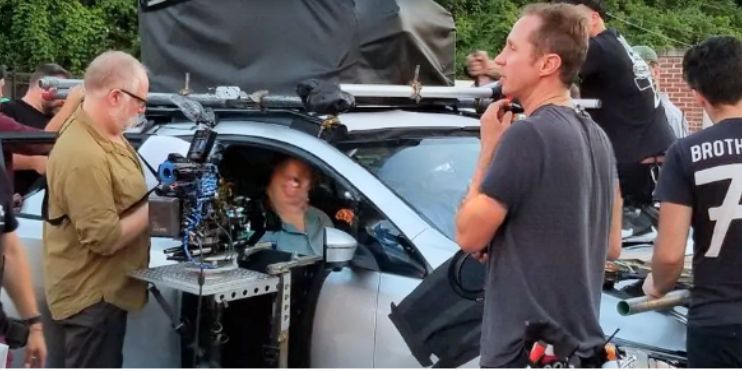 A man prepares to drive a car, showcasing the innovative vehicle filming technology by Creative Control Systems.