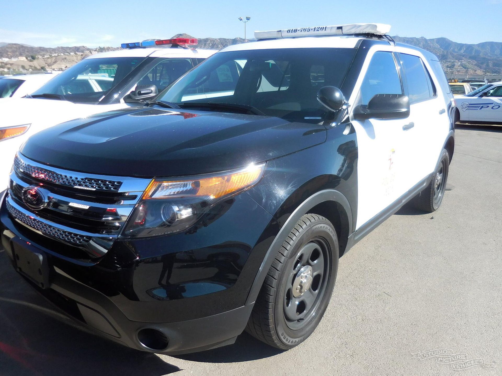 A black and white car is parked and ready to install pod rigs for film shooting.
