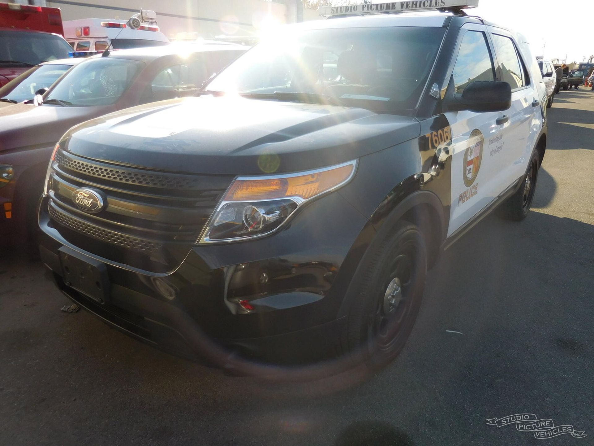 A black and white car is parked and ready to install pod rigs for film shooting.