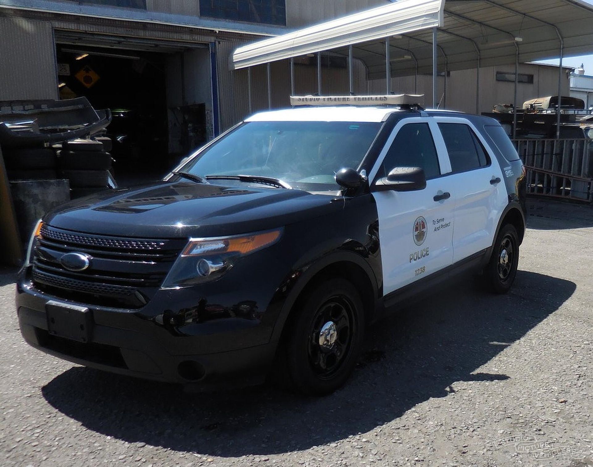 A black and white police car is parked and ready to install pod rigs for film shooting.