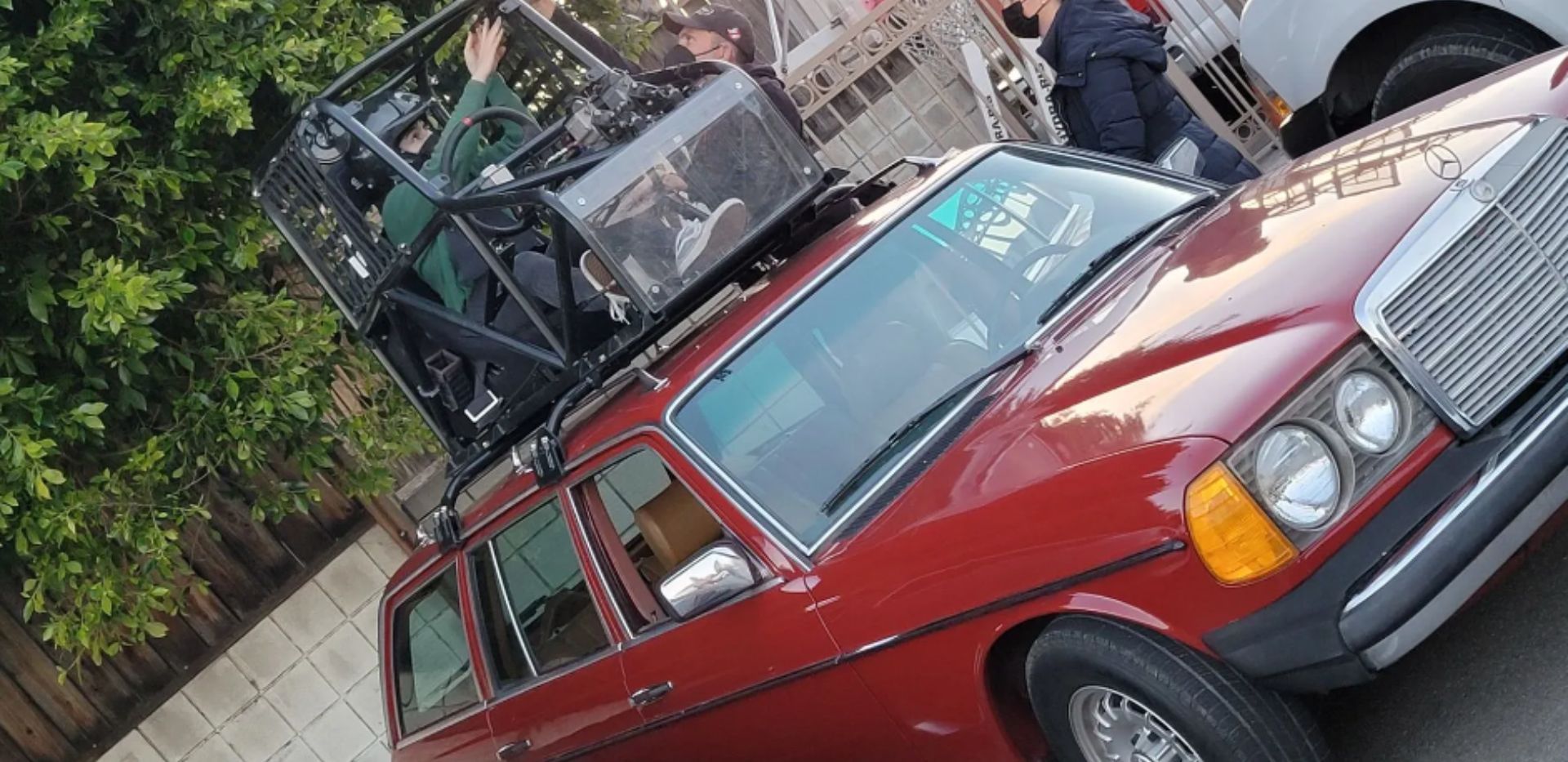 A red car featuring a roof rack, symbolizing innovation and versatility in transportation solutions.