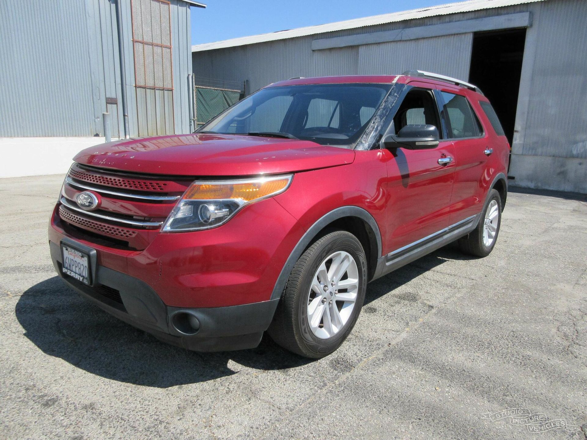 A red Ford Explorer is parked and ready to install pod rigs for film shooting.