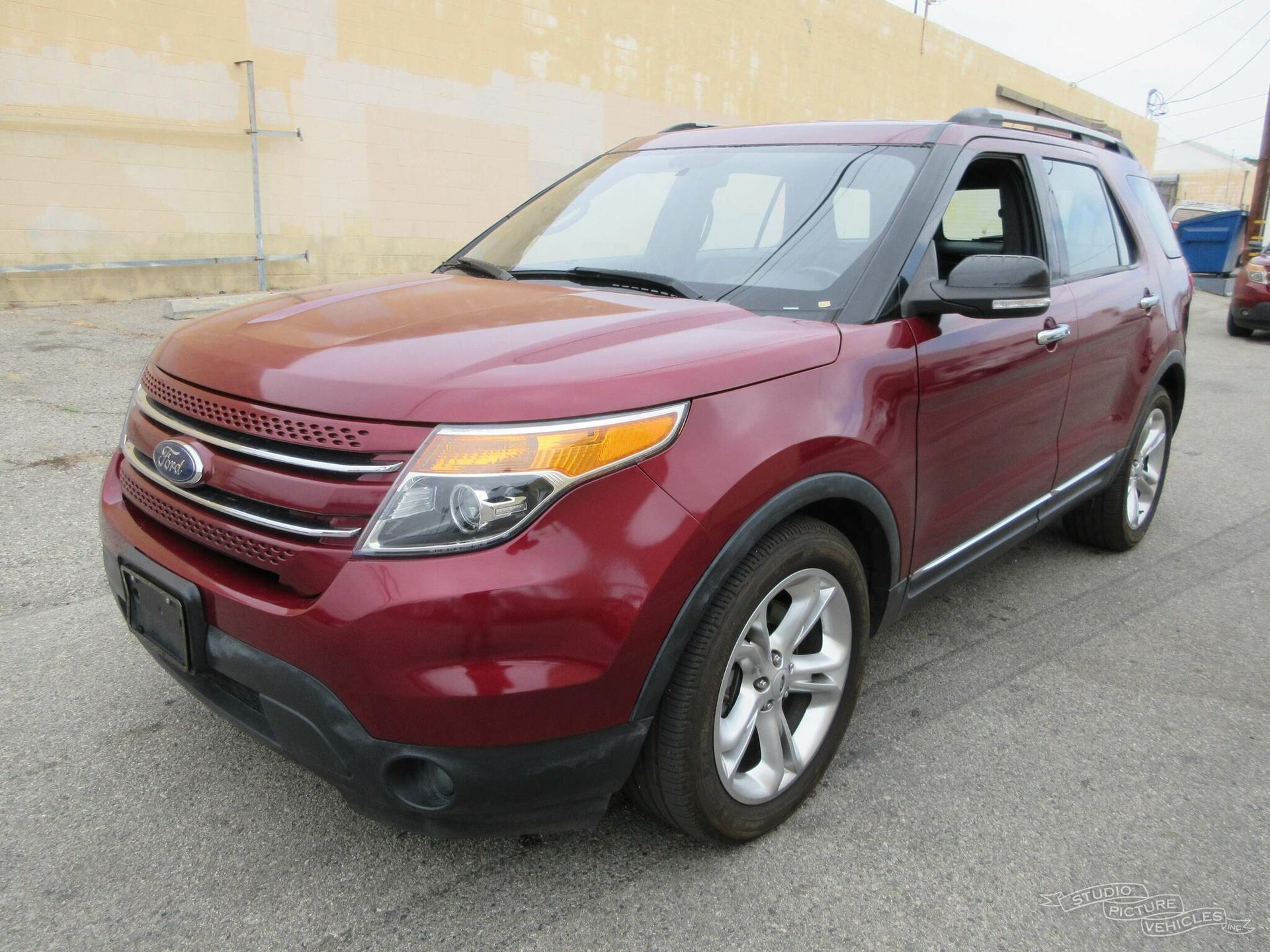 A red Ford Explorer is parked and ready to install a pod rig for film shooting.
