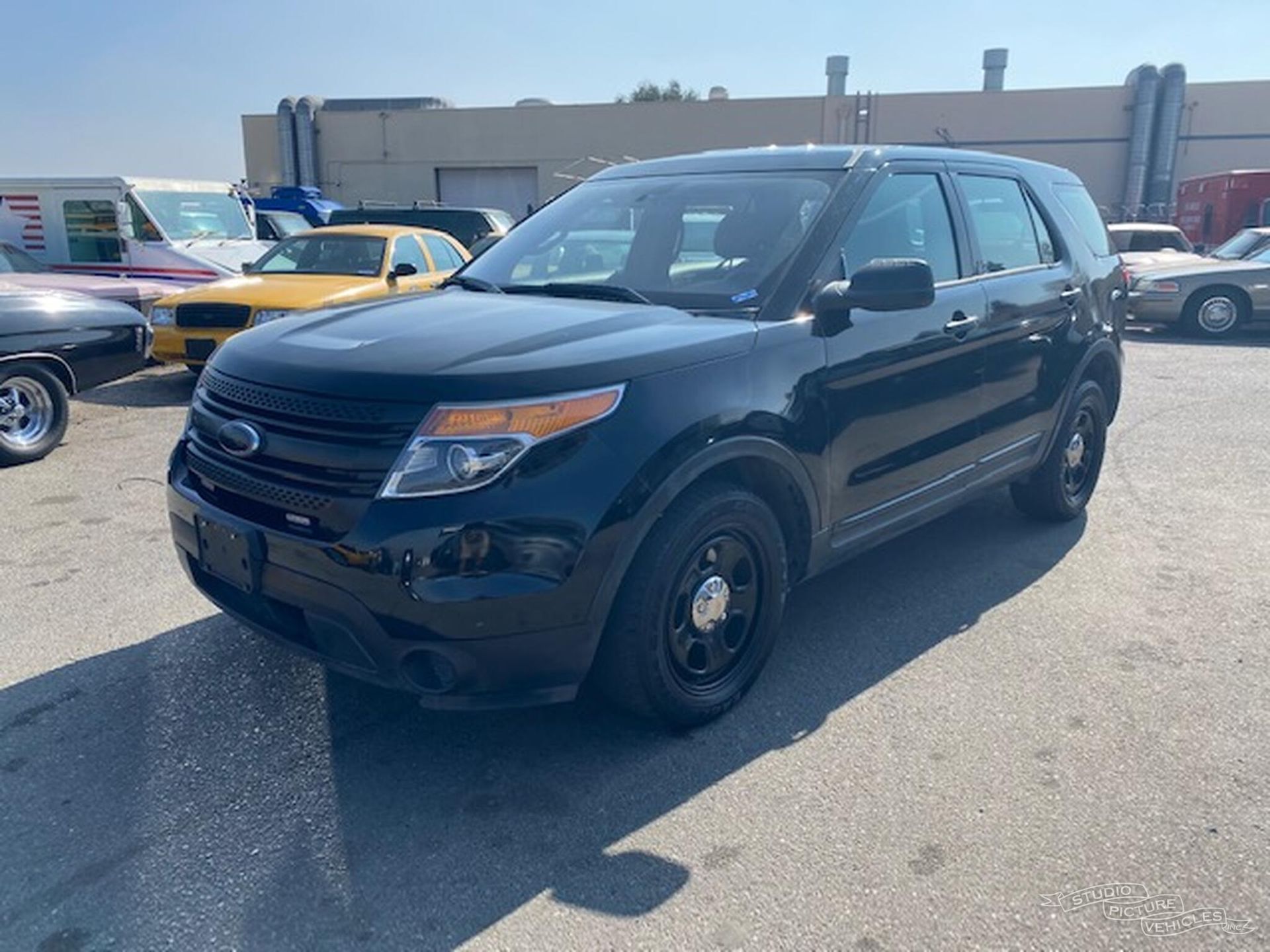 A black and white police car is parked and ready to install pod rigs for film shooting.