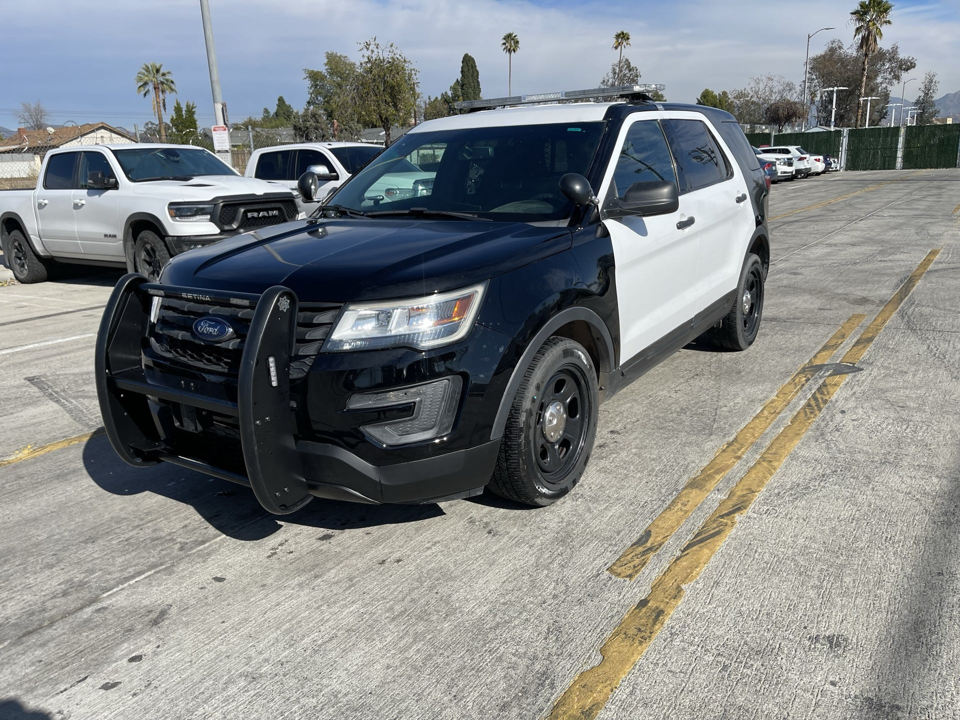 A black and white police car is parked and ready to install pod rigs for film shooting.