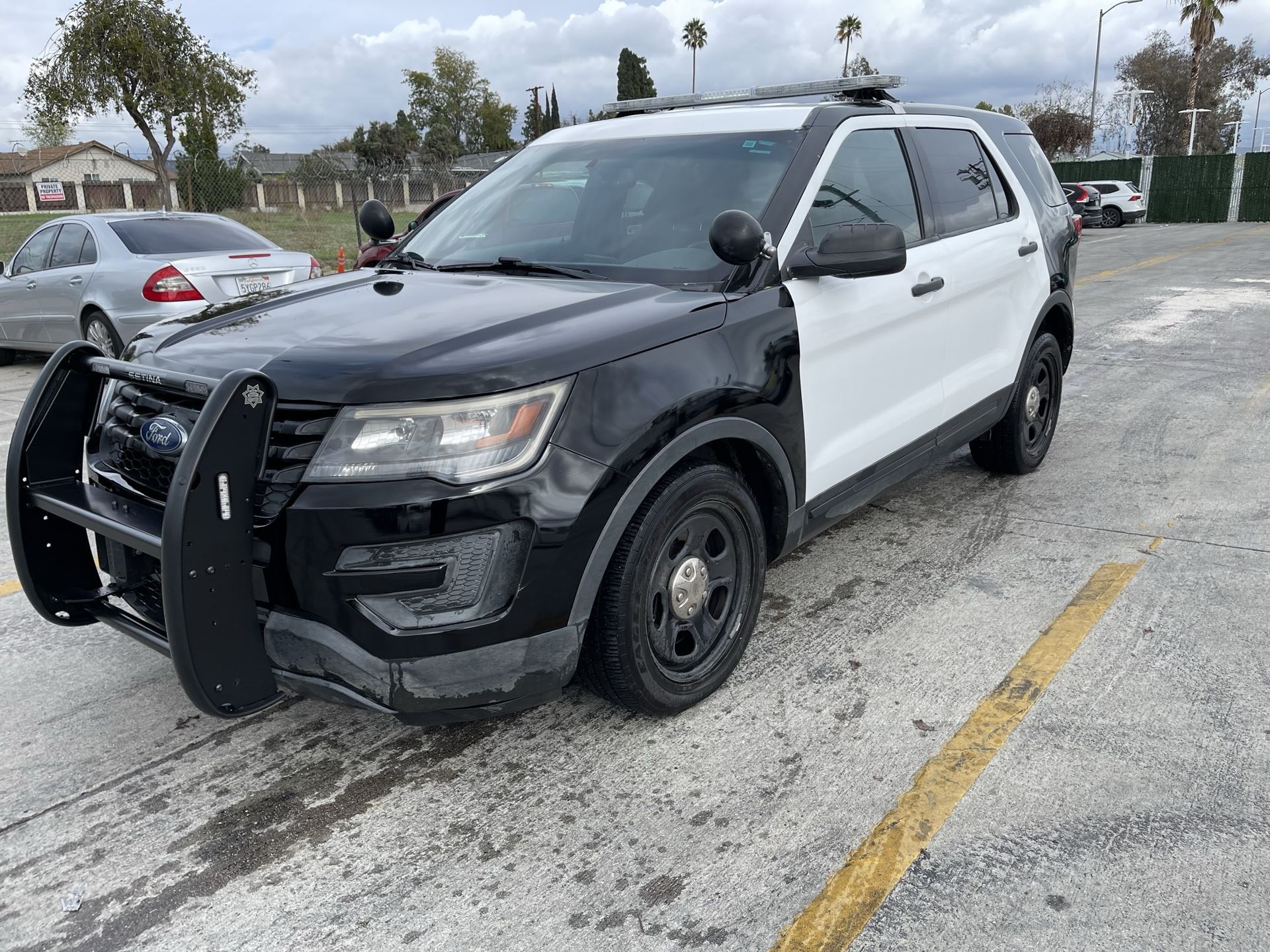 A black and white police car is parked and ready to install pod rigs for film shooting.