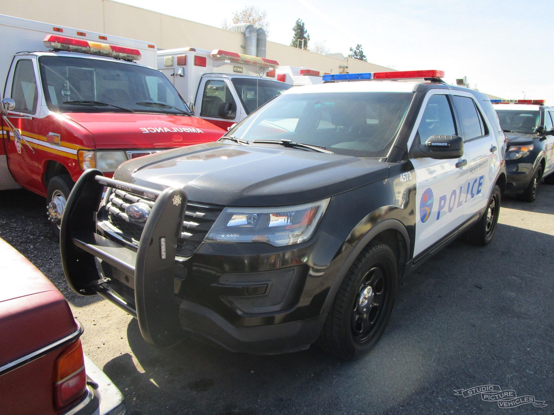 A black and white police car is parked and ready to install pod rigs for film shooting.
