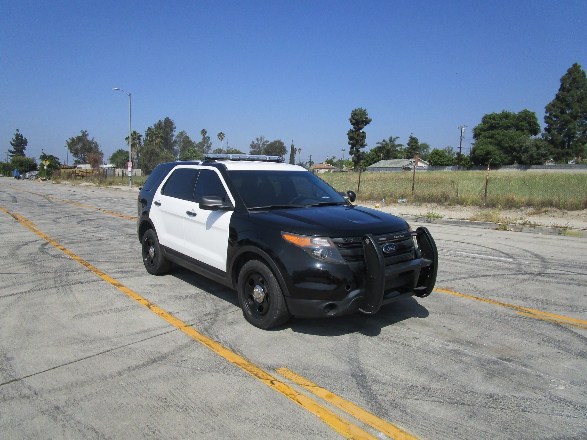 A black and white police car is parked and ready to install pod rigs for film shooting.