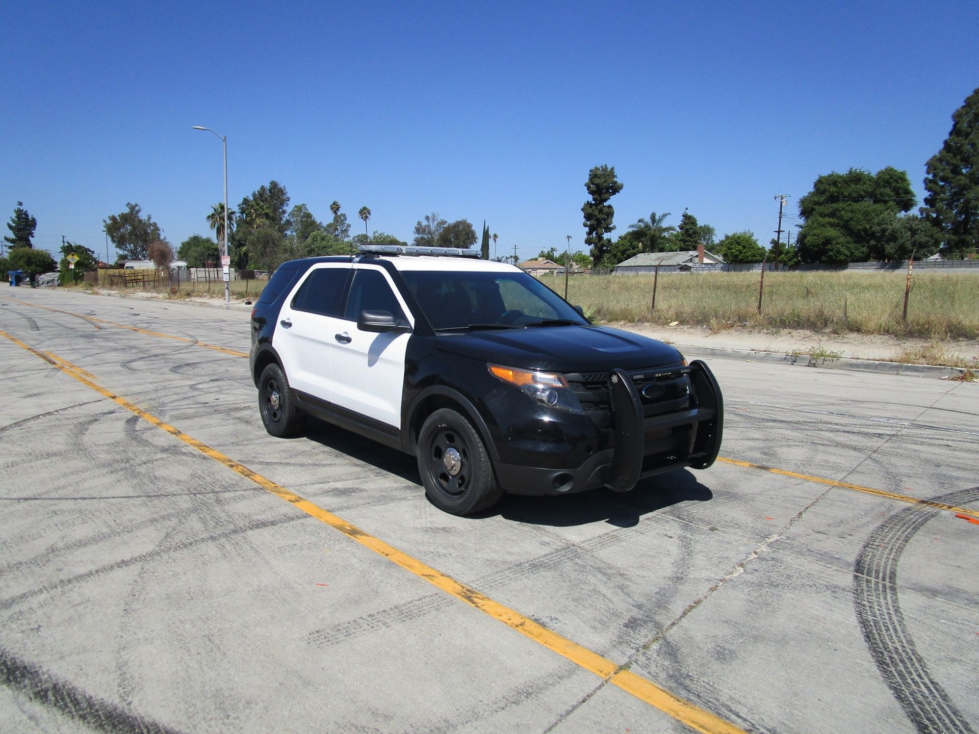 A black and white police car is parked and ready to install pod rigs for film shooting.