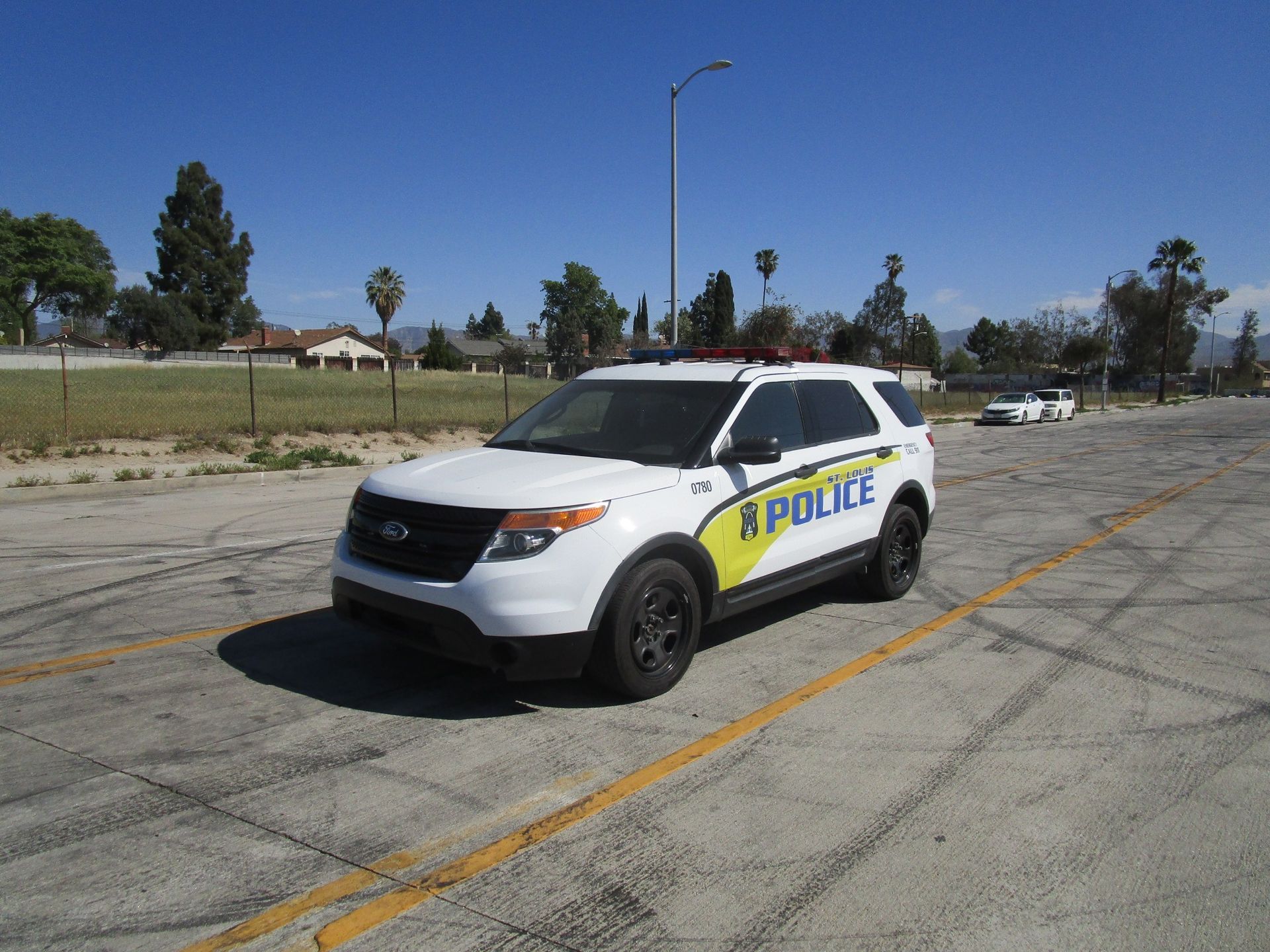 A black and white police car is parked and ready to install pod rigs for film shooting.
