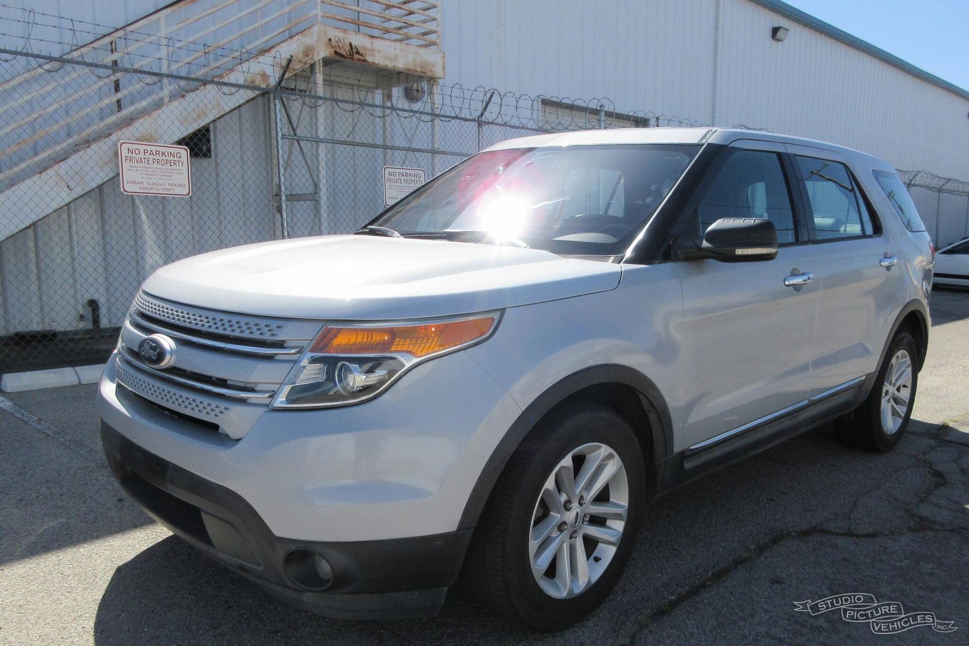 a white ford explorer is parked and ready to install a pod rig for film shooting.