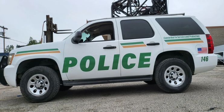 A police vehicle parked in front of a building, emphasizing law enforcement presence and community safety.