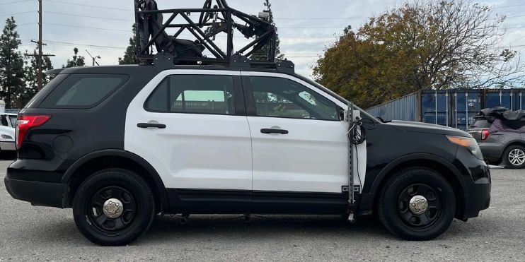 A police vehicle equipped with a camera on top, showcasing advanced surveillance capabilities for enhanced security operations.