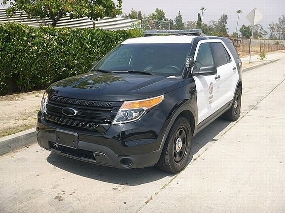 A black and white police car is parked and ready to install pod rigs for film shooting.
