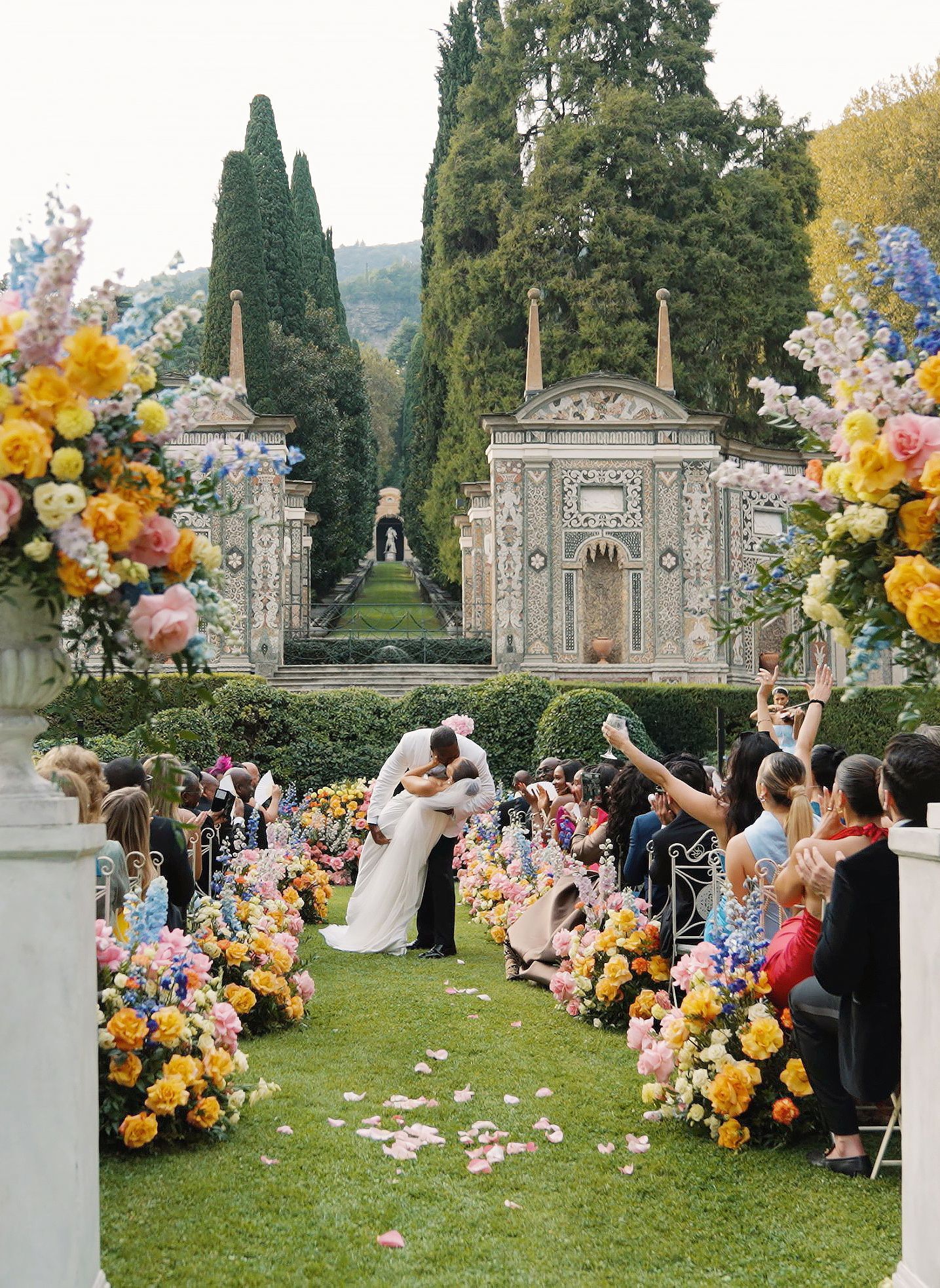 Luxury wedding ceremony at Villa d’Este Lake Como with floral aisle and historic garden