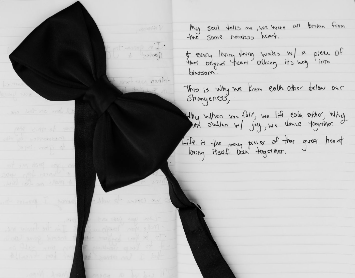 Black and white wedding detail of bow tie and handwritten vows captured in editorial style
