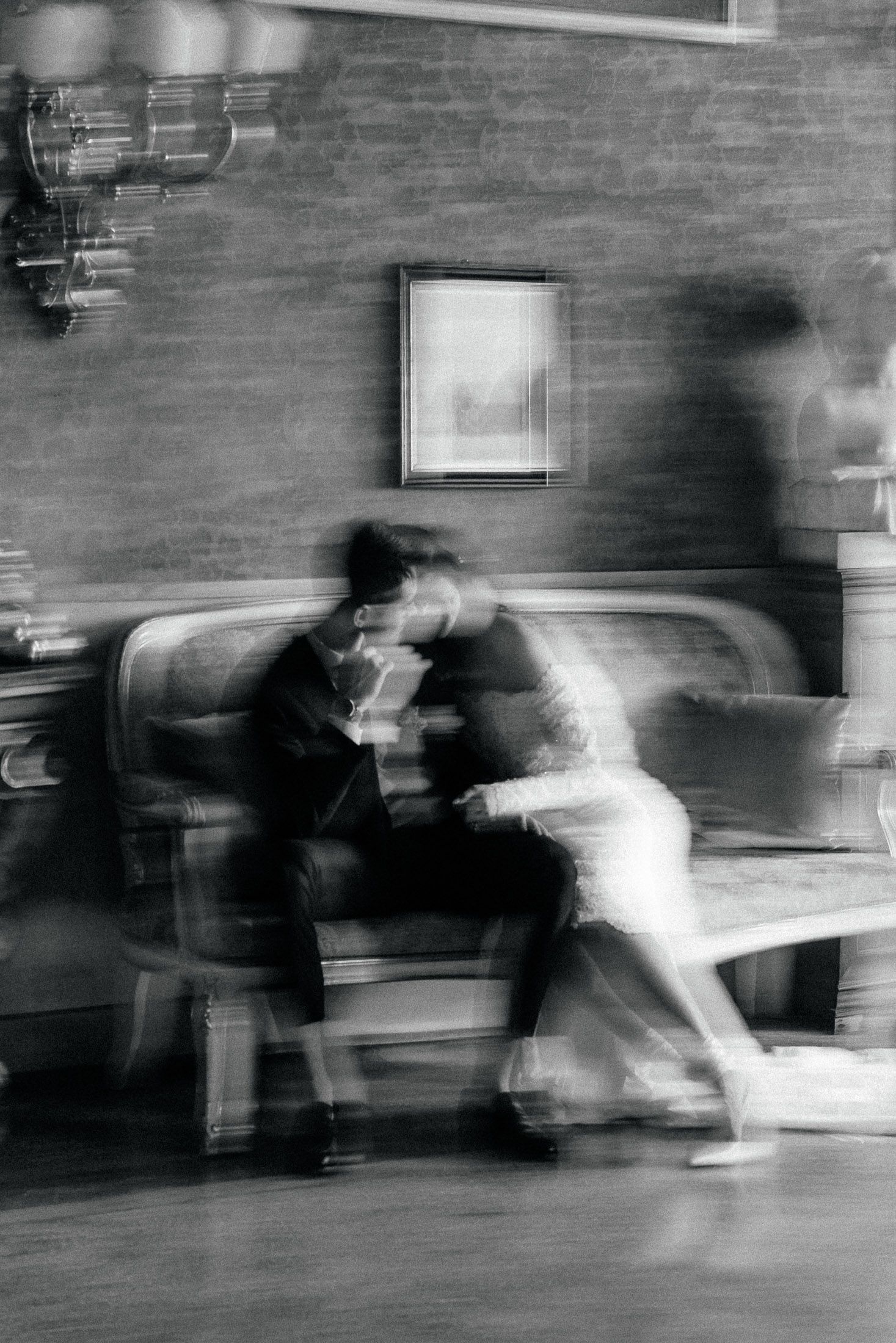 Artistic black and white motion blur of couple during wedding moment captured in editorial style