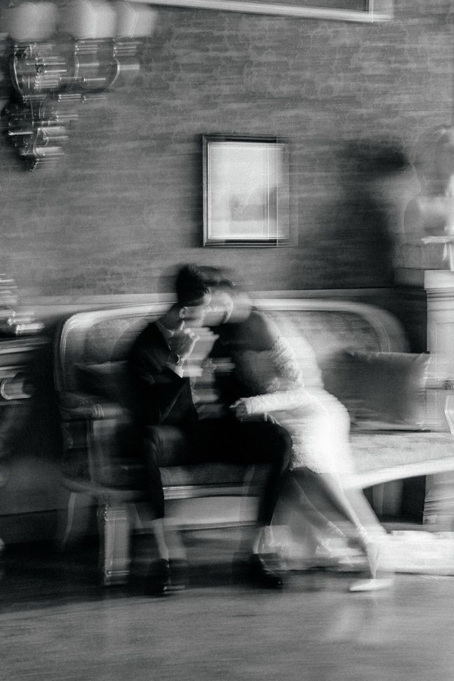 Artistic black and white motion blur of couple during wedding moment captured in editorial style