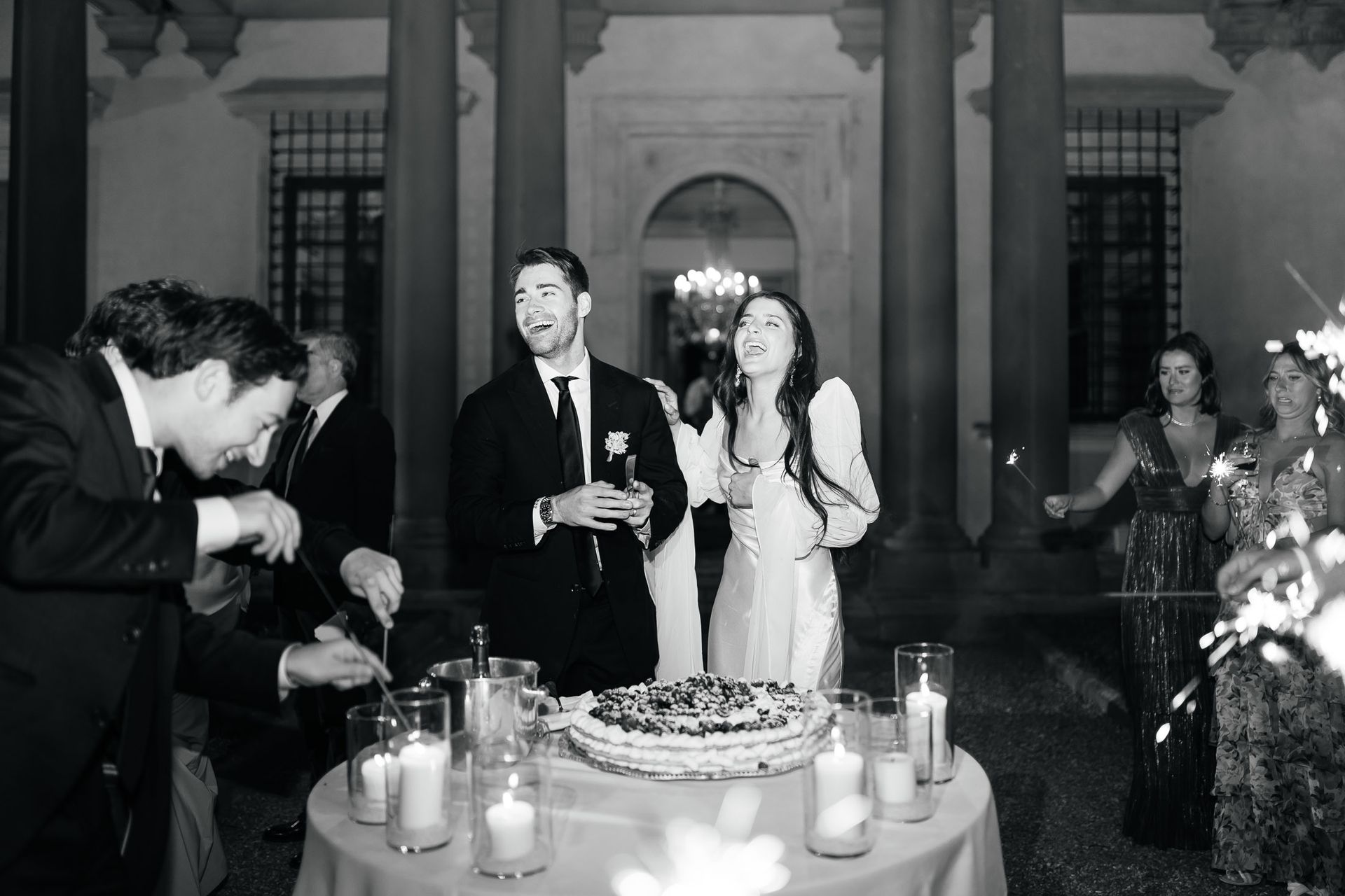 Wedding cake cutting moment at Villa di Maiano Florence in black and white editorial wedding photography