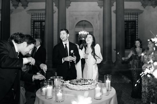 Wedding cake cutting moment at Villa di Maiano Florence in black and white editorial wedding photography