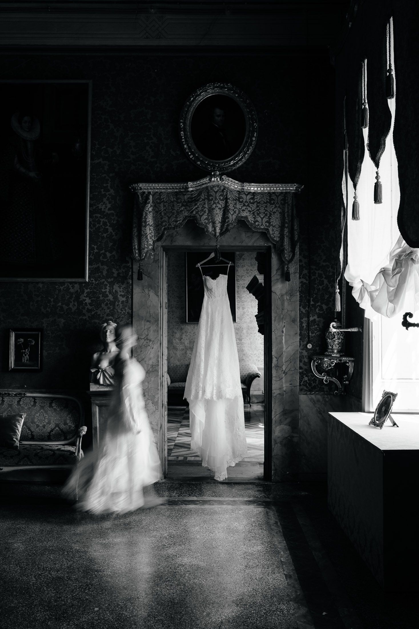 Wedding dress hanging in historic Italian villa captured in timeless editorial wedding photography