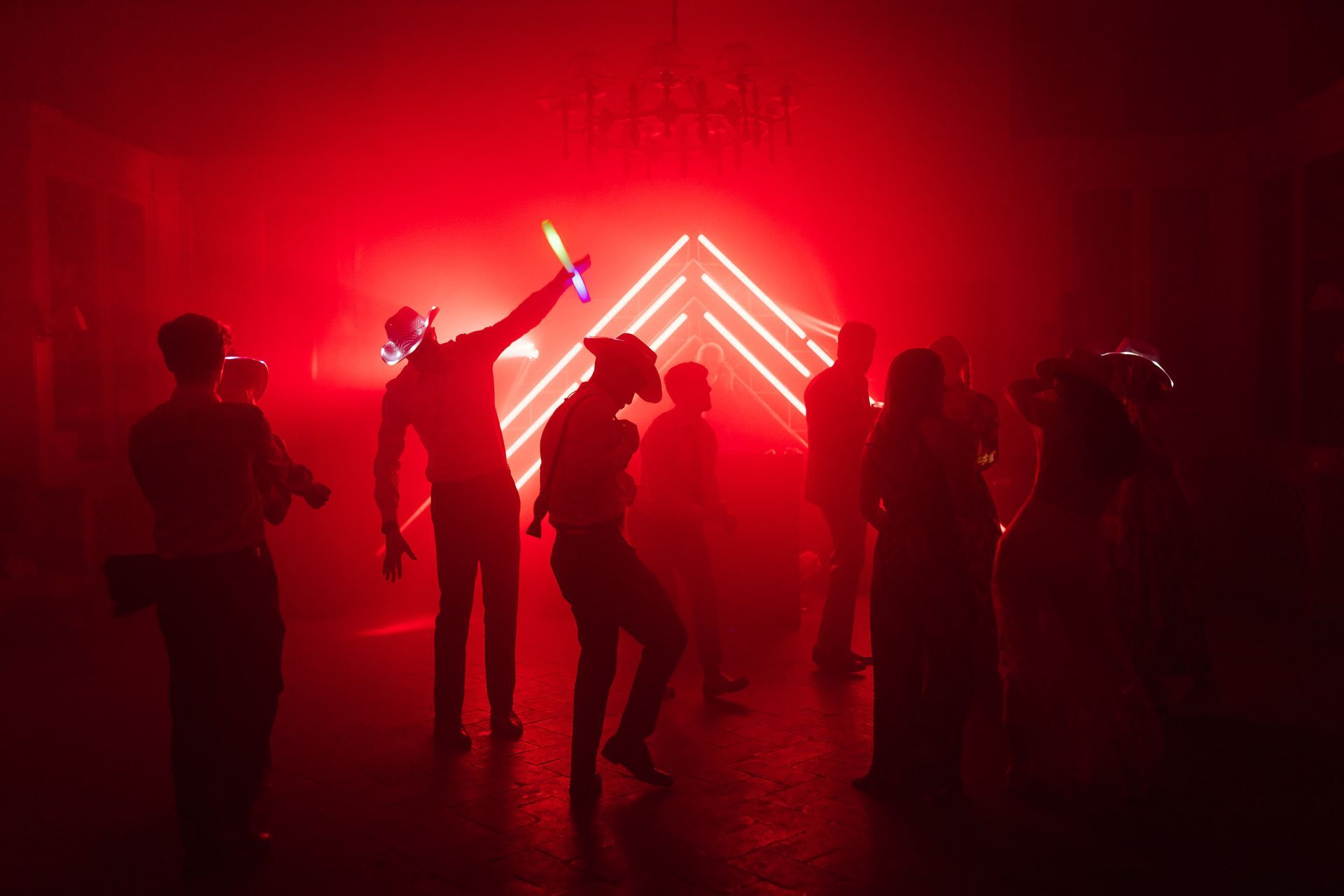 Wedding party at Villa Le Fontanelle Tuscany with red lights and dancing guests during luxury wedding