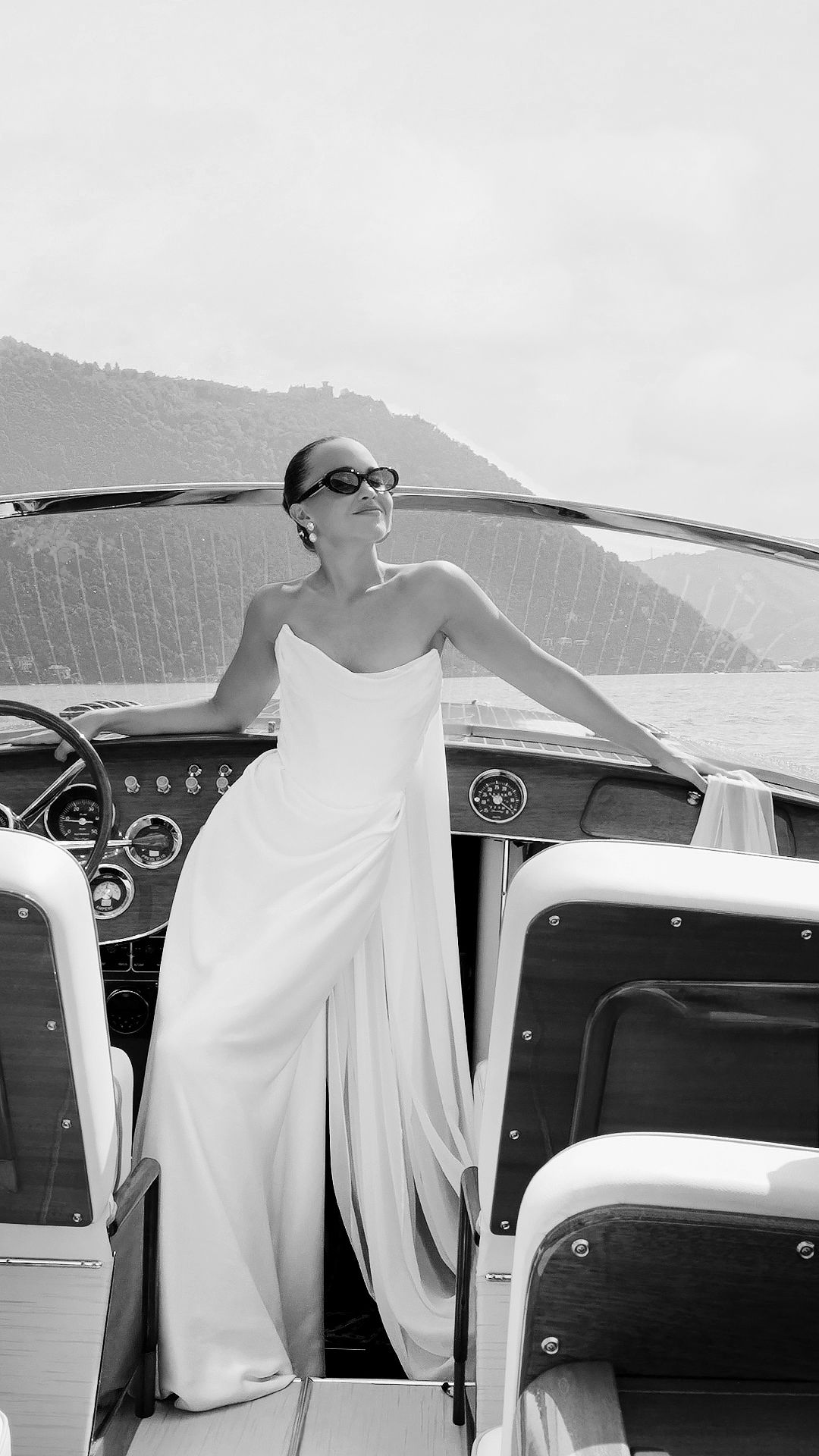 Bride on boat at Villa Pizzo Lake Como during luxury wedding captured in editorial style